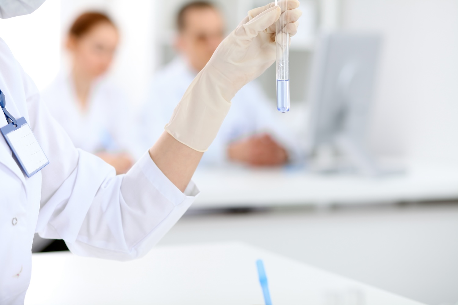 Scientific research team with clear solution in laboratory