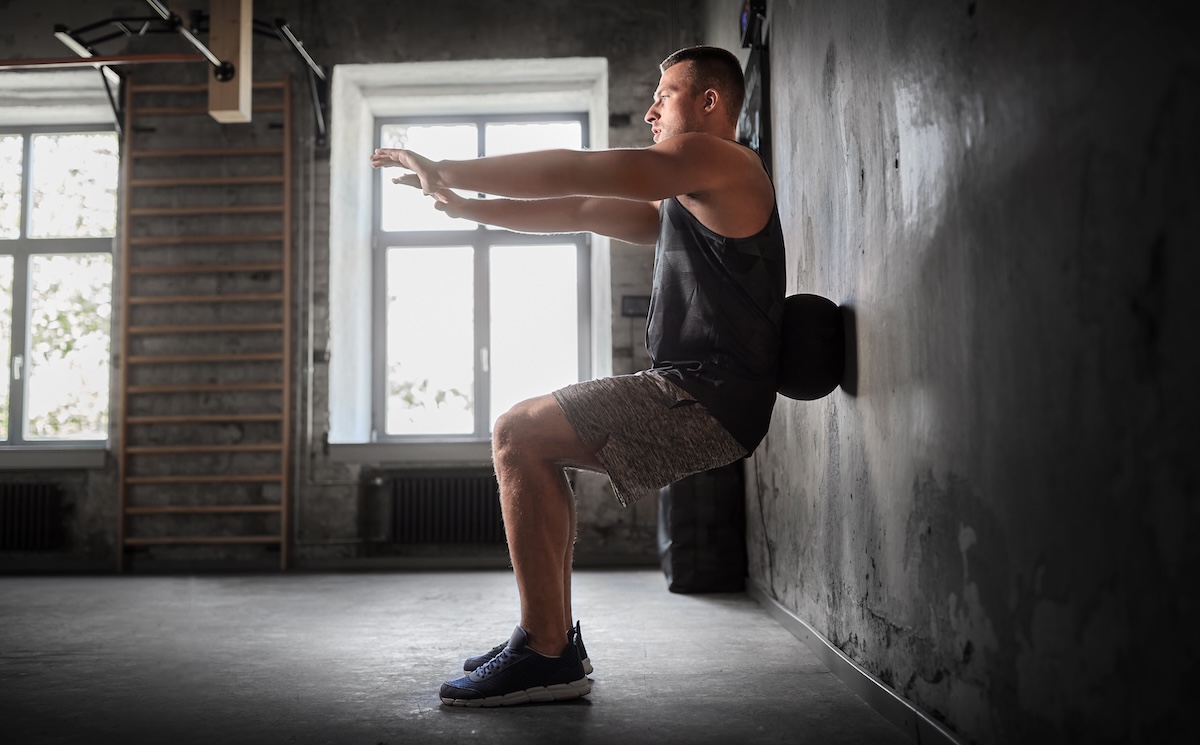 young man exercising with medicine ball in gym